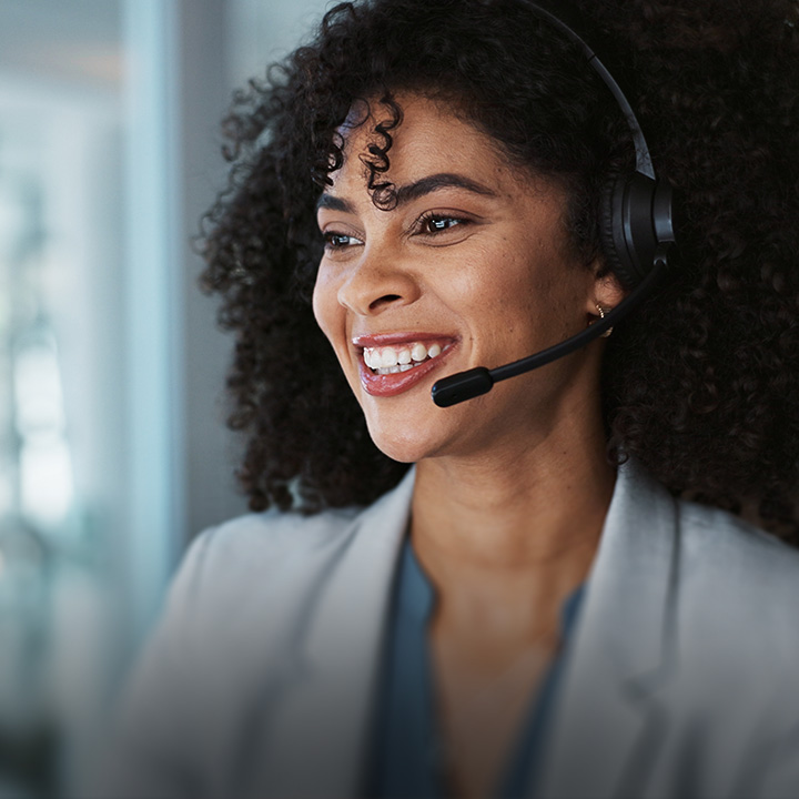 smiling woman on headset. Text: Contact Us